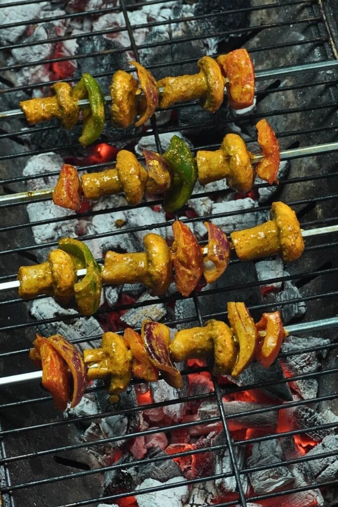BBQ Grilled Mushroom Skewers skewers on hot charcoal